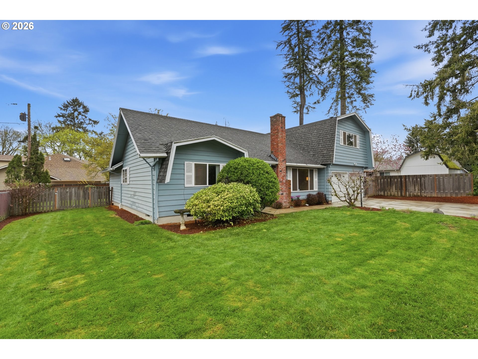 335 Southwest 141st Avenue Beaverton, OR 97006 - Photo 2 of 42 a front view of a house with a yard