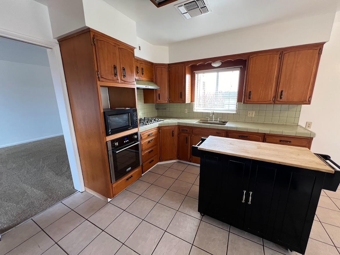 16109 East Manning Reedley, CA 93654 - Photo 8 of 30 a kitchen with a sink stove and microwave