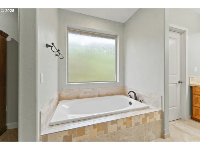 a bath tub sitting next to a window