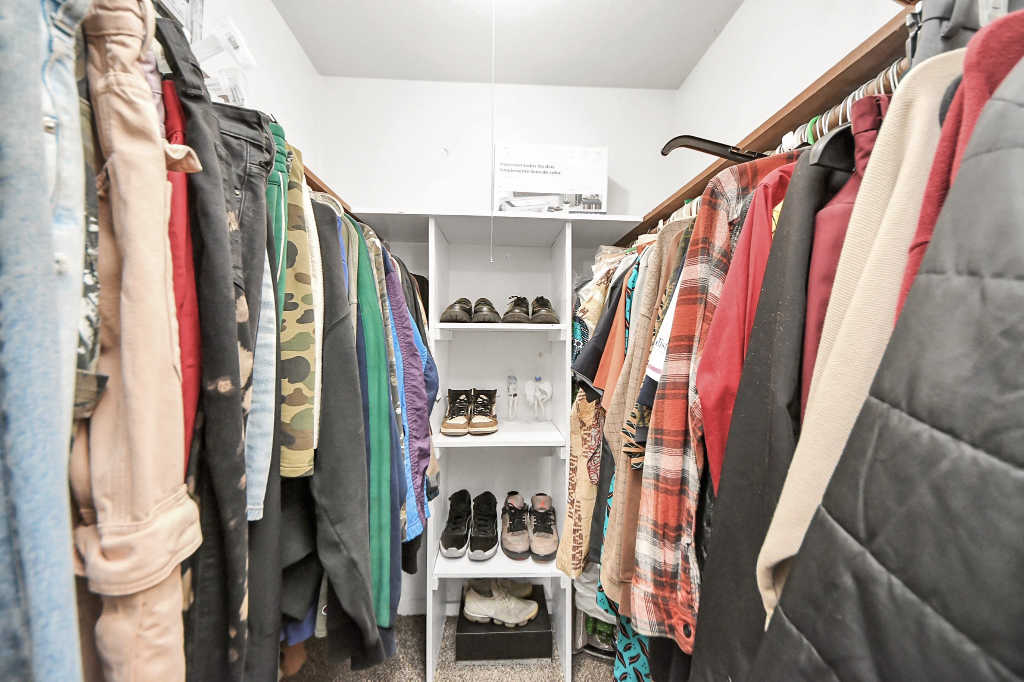4155 Amir Street Houston, TX 77072 - Photo 34 of 43 a view of walk in closet with clothes and shoes