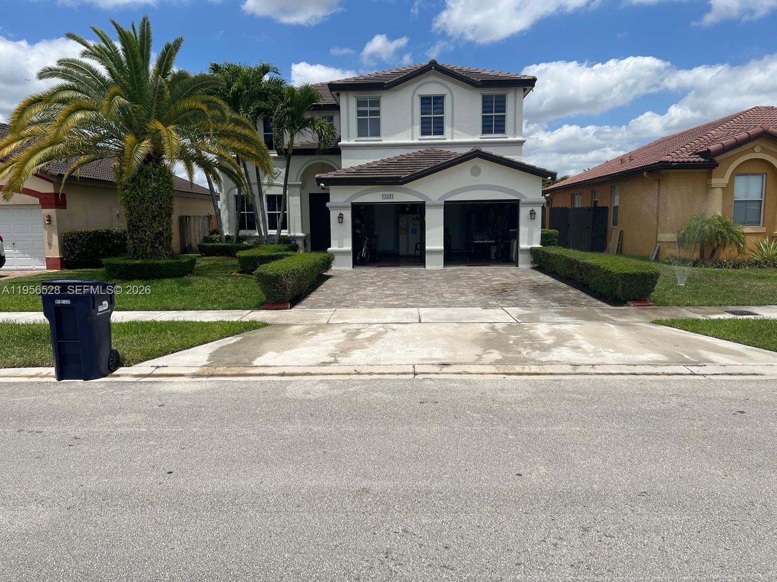a front view of a house with a yard and a garage