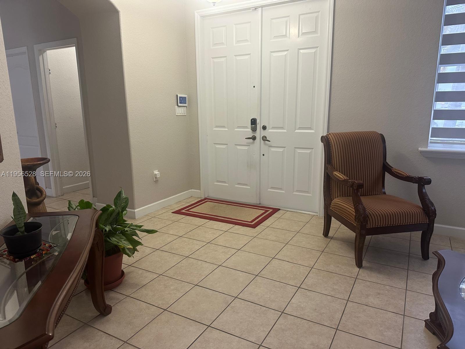 15541 Southwest 21st Terrace Miami, FL 33185 - Photo 11 of 21 a bedroom with a bed and a chair