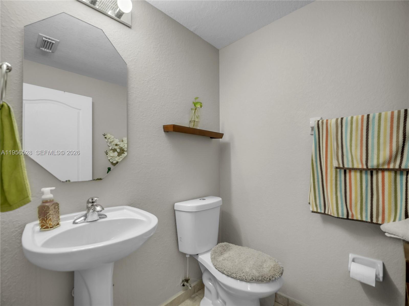 15541 Southwest 21st Terrace Miami, FL 33185 - Photo 12 of 34 a bathroom with a sink a toilet and mirror