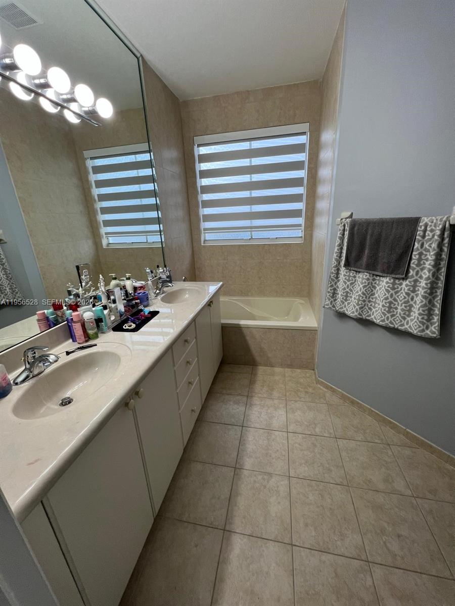 15541 Southwest 21st Terrace Miami, FL 33185 - Photo 13 of 21 a bathroom with a tub sink and mirror