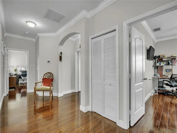 a living room with furniture and wooden floor
