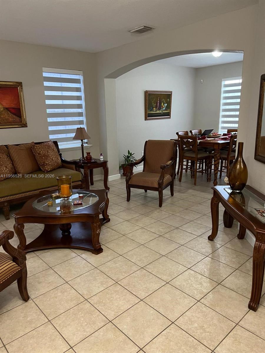 15541 Southwest 21st Terrace Miami, FL 33185 - Photo 17 of 21 a living room with furniture and a piano