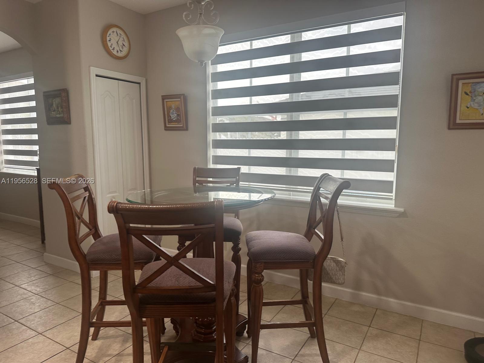 15541 Southwest 21st Terrace Miami, FL 33185 - Photo 18 of 21 a view of a dining room with furniture and a window
