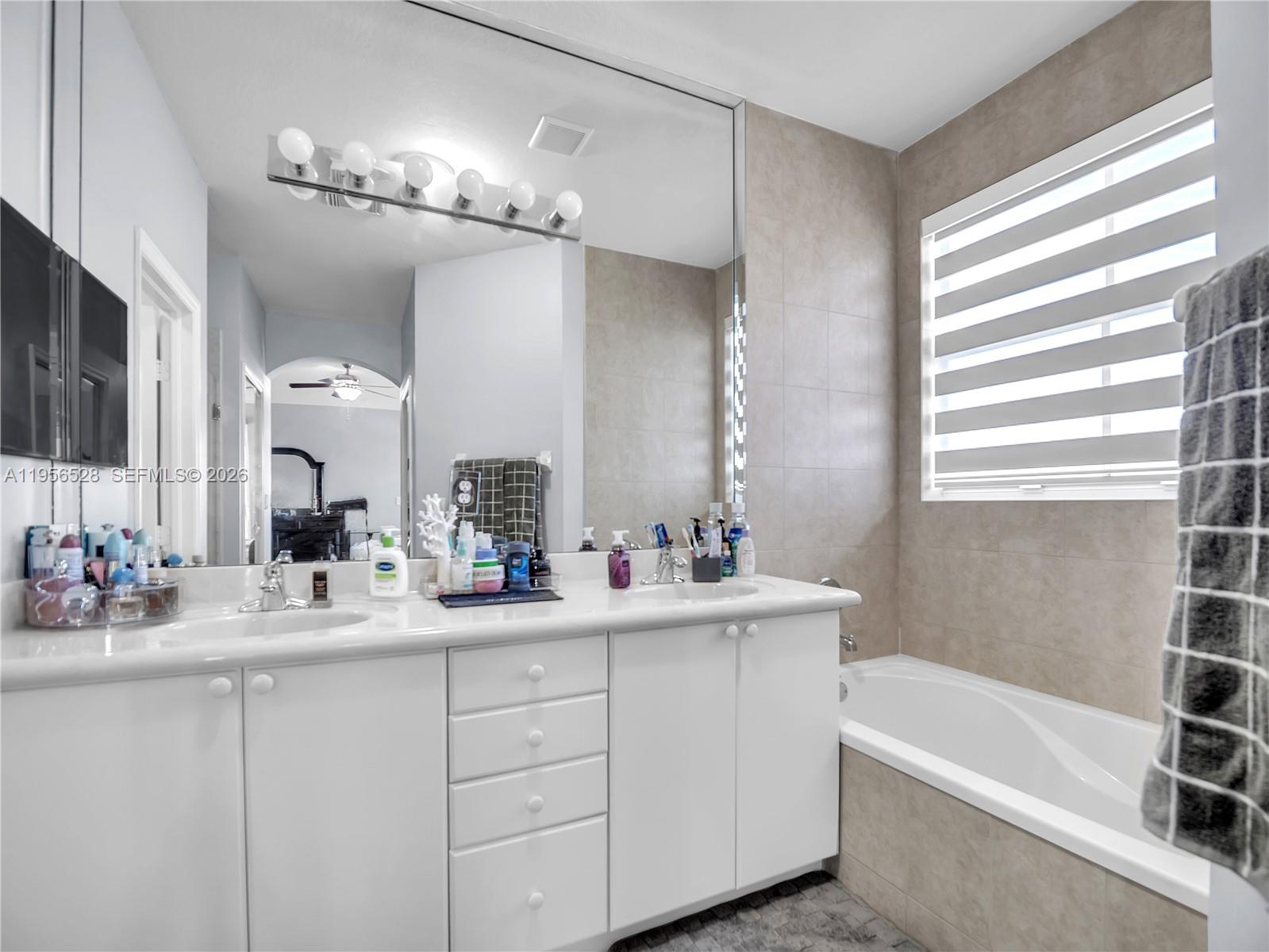15541 Southwest 21st Terrace Miami, FL 33185 - Photo 19 of 34 a bathroom with a tub sink and mirror