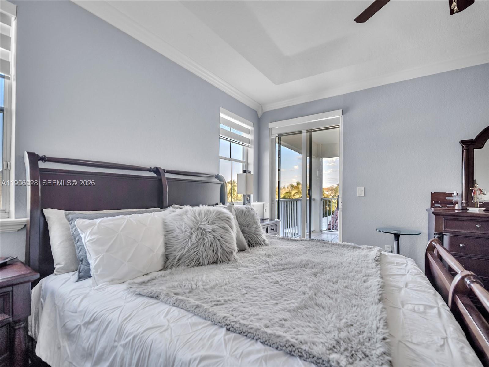 15541 Southwest 21st Terrace Miami, FL 33185 - Photo 22 of 34 a bedroom with a large bed and a tv