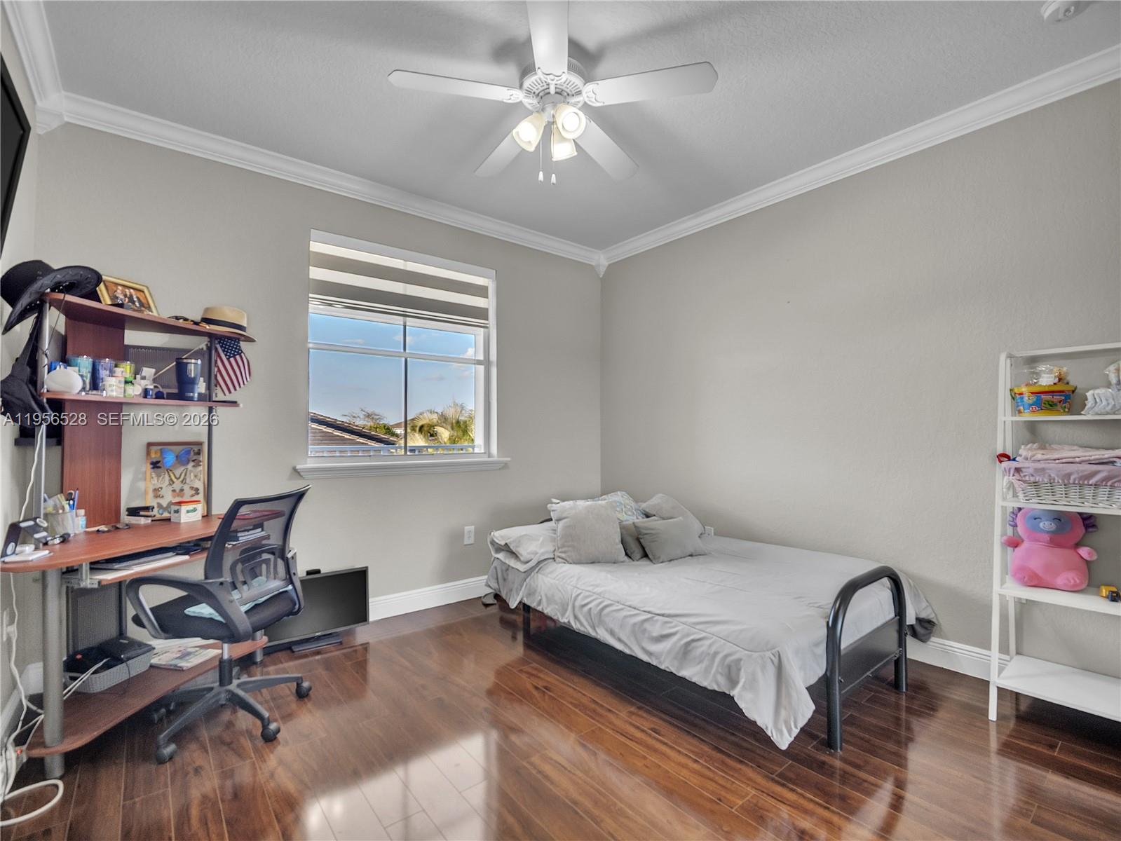 15541 Southwest 21st Terrace Miami, FL 33185 - Photo 27 of 34 a bedroom with a bed and a chandelier