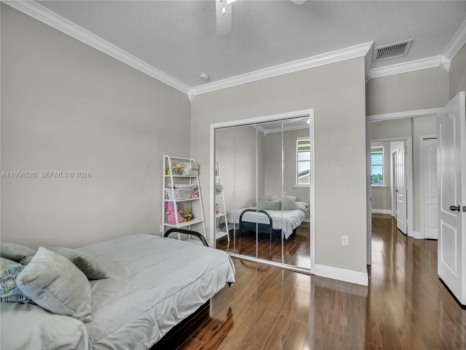 15541 Southwest 21st Terrace Miami, FL 33185 - Photo 28 of 34 a bedroom with furniture and a wooden floor
