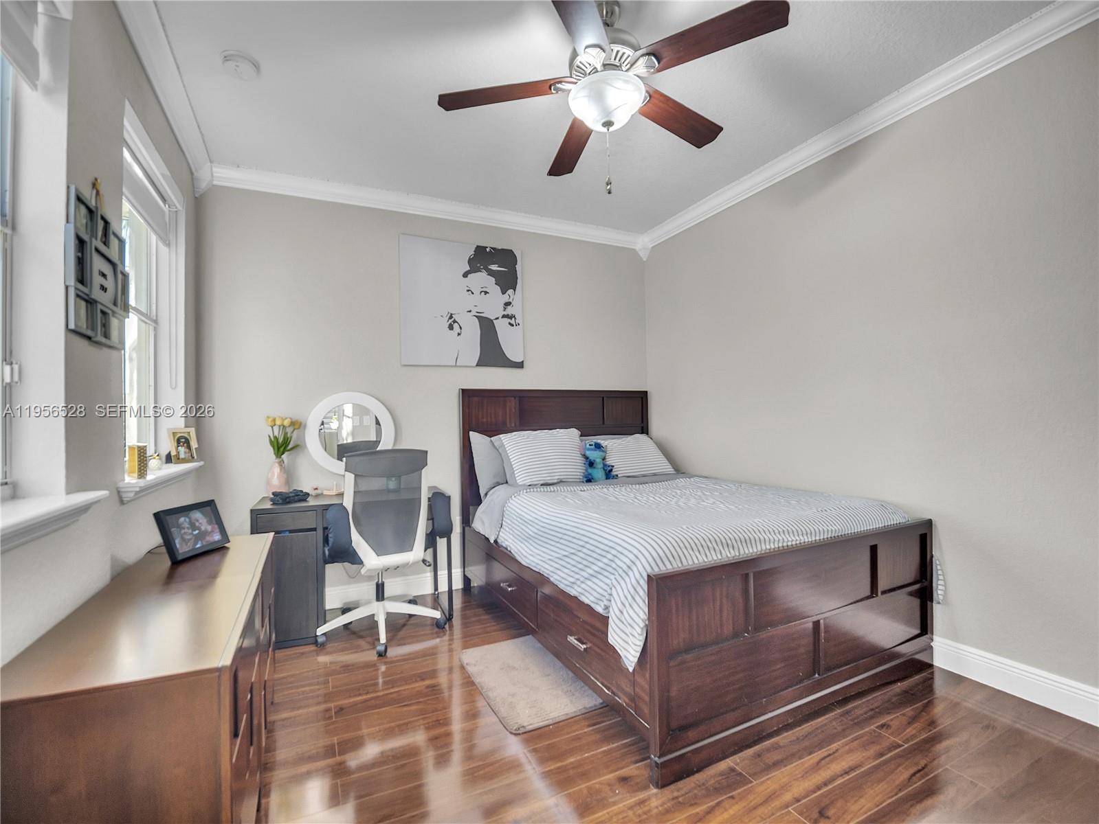 15541 Southwest 21st Terrace Miami, FL 33185 - Photo 29 of 34 a bedroom with a bed and a chandelier