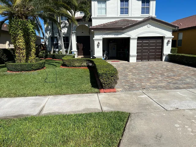 a front view of a house with a yard and garage
