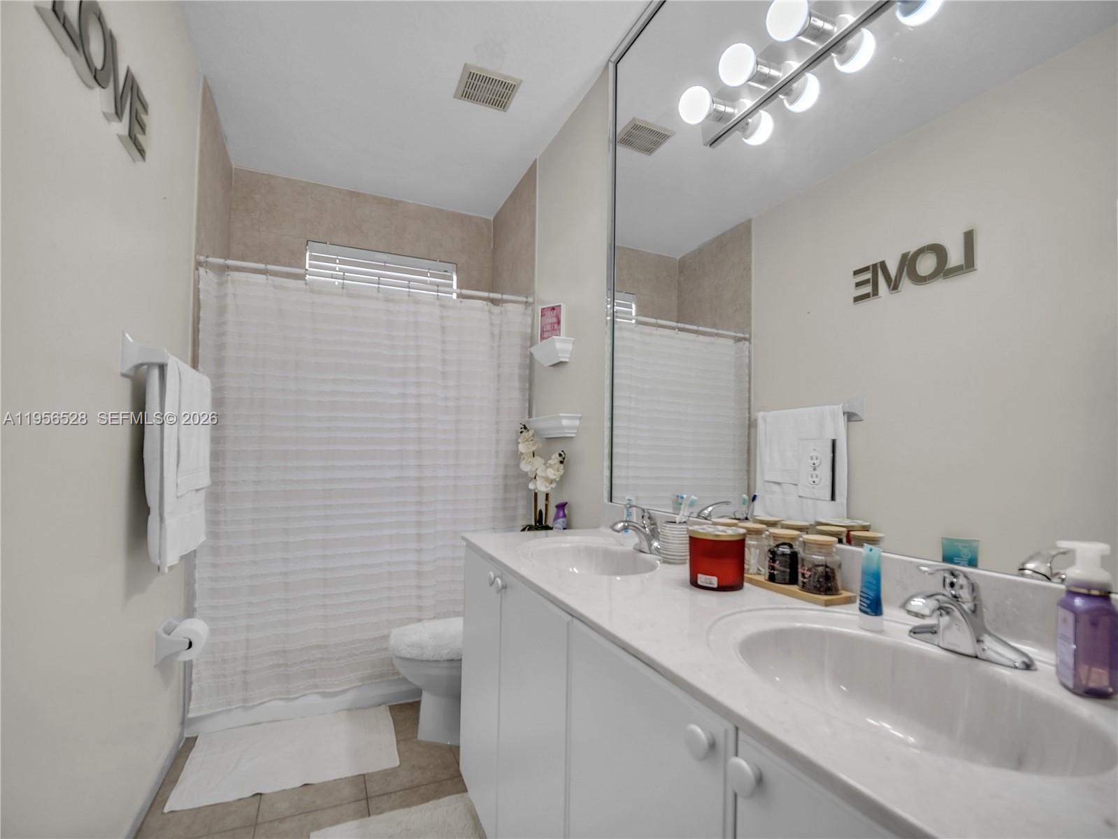 15541 Southwest 21st Terrace Miami, FL 33185 - Photo 31 of 34 a bathroom with a sink a toilet and shower
