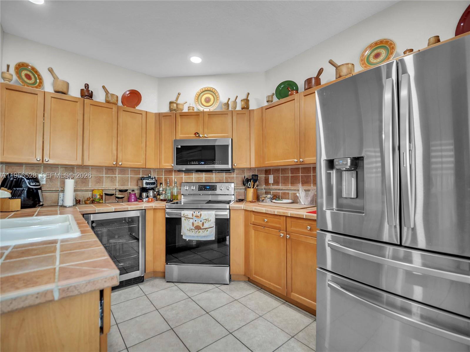 15541 Southwest 21st Terrace Miami, FL 33185 - Photo 7 of 34 a kitchen with a refrigerator and a sink
