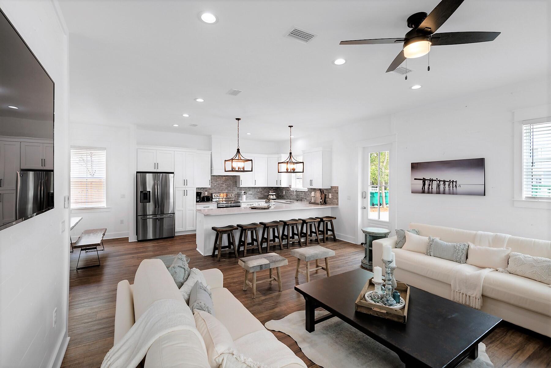 4458 Luke Avenue Destin, FL 32541 - Photo 14 of 41 a living room with furniture kitchen view and a refrigerator