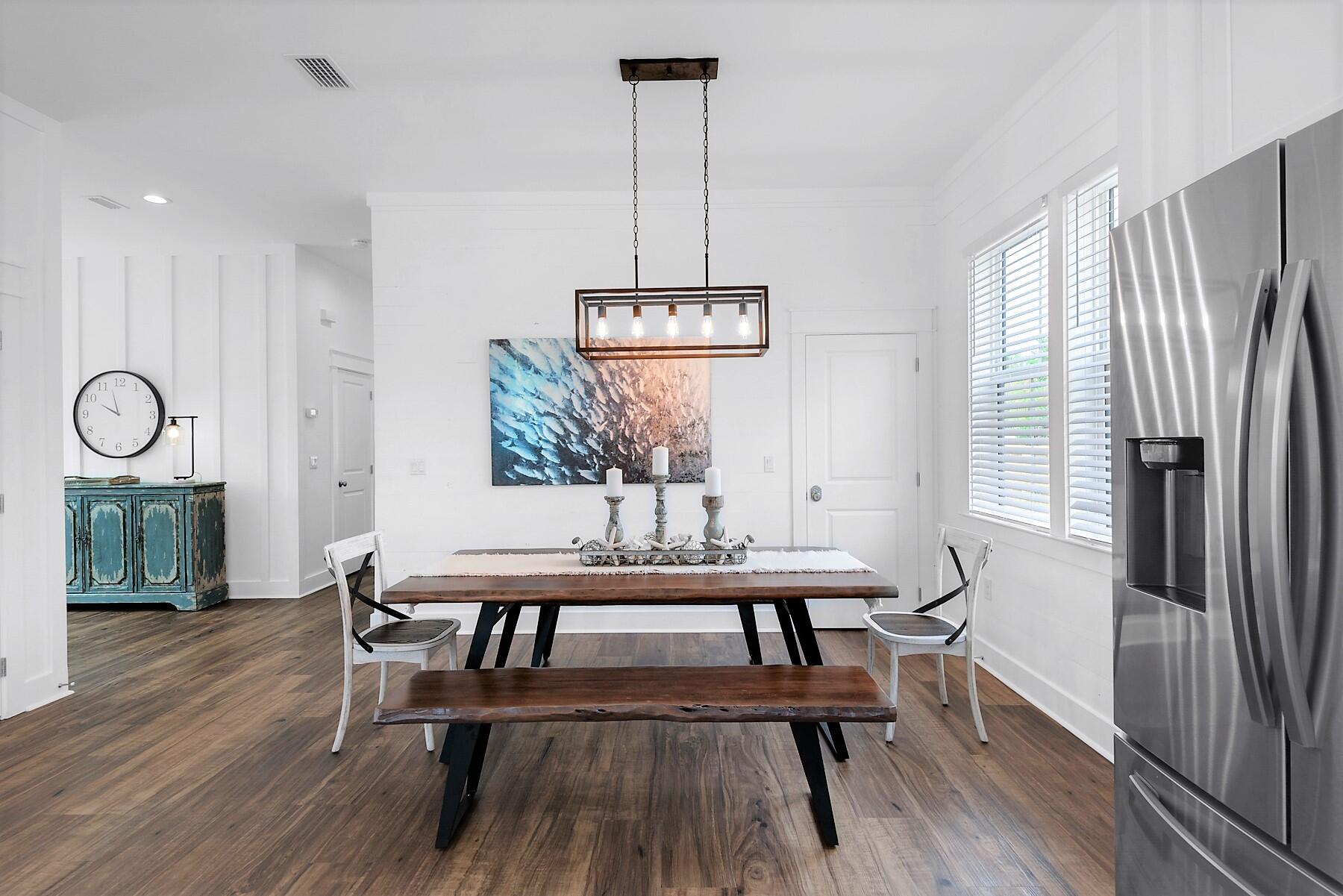 4458 Luke Avenue Destin, FL 32541 - Photo 16 of 41 a view of a dining room with furniture window and wooden floor