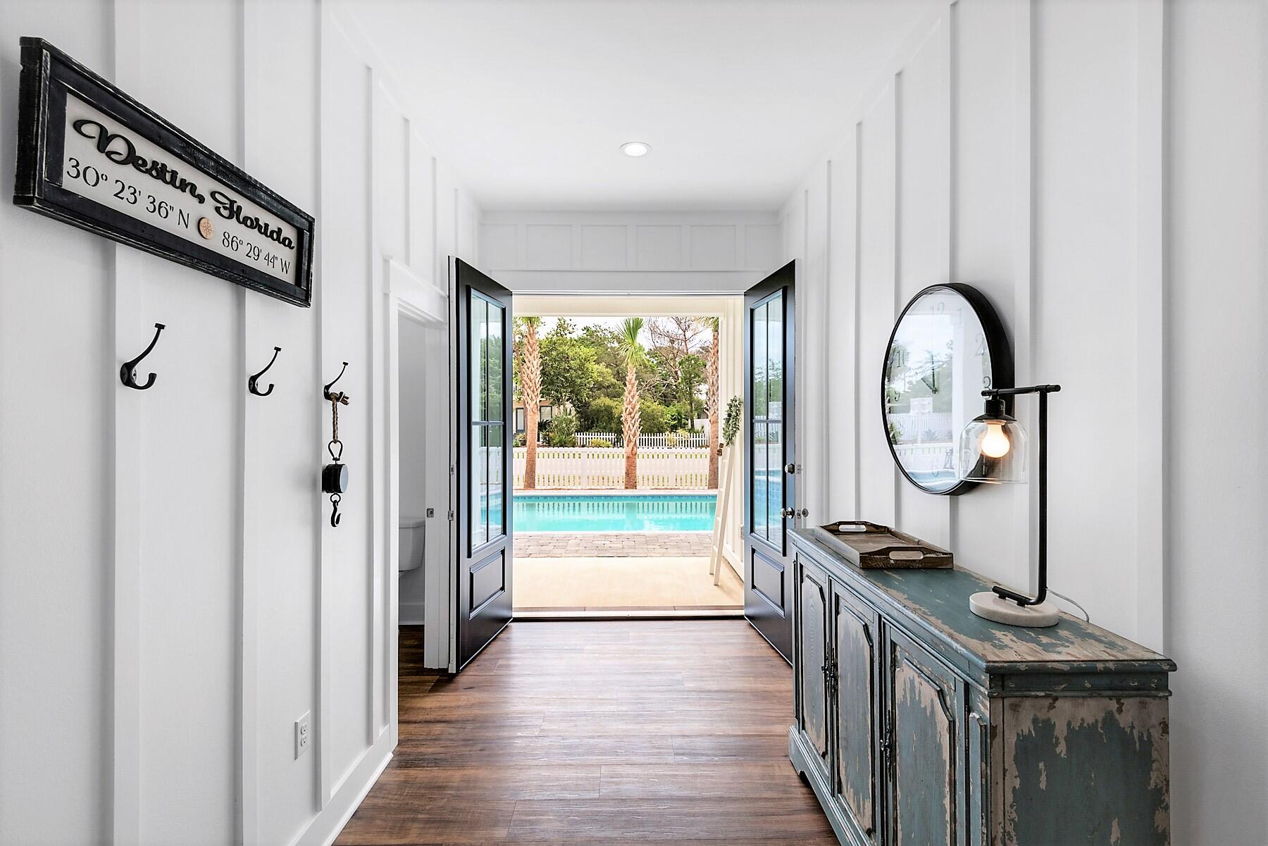 4458 Luke Avenue Destin, FL 32541 - Photo 17 of 41 a view of a hallway with wooden floor and windows