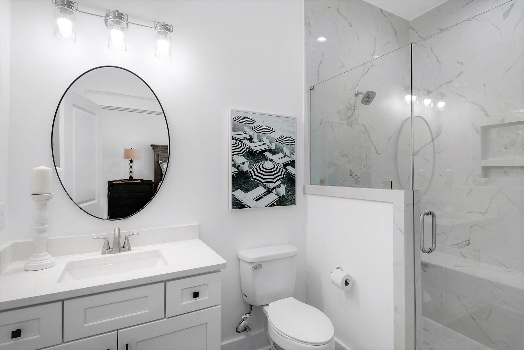 4458 Luke Avenue Destin, FL 32541 - Photo 20 of 41 a bathroom with a toilet sink and mirror