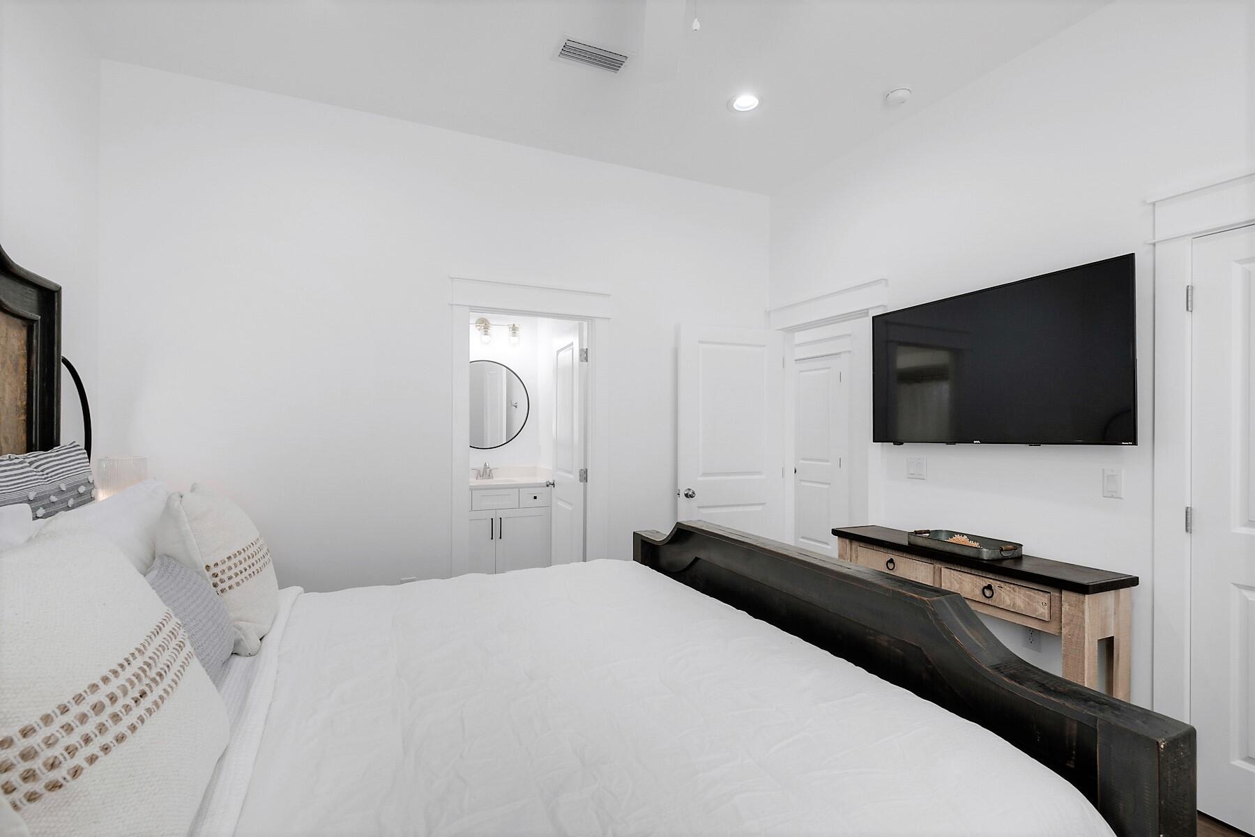 4458 Luke Avenue Destin, FL 32541 - Photo 22 of 41 a bedroom with a bed and a flat screen tv
