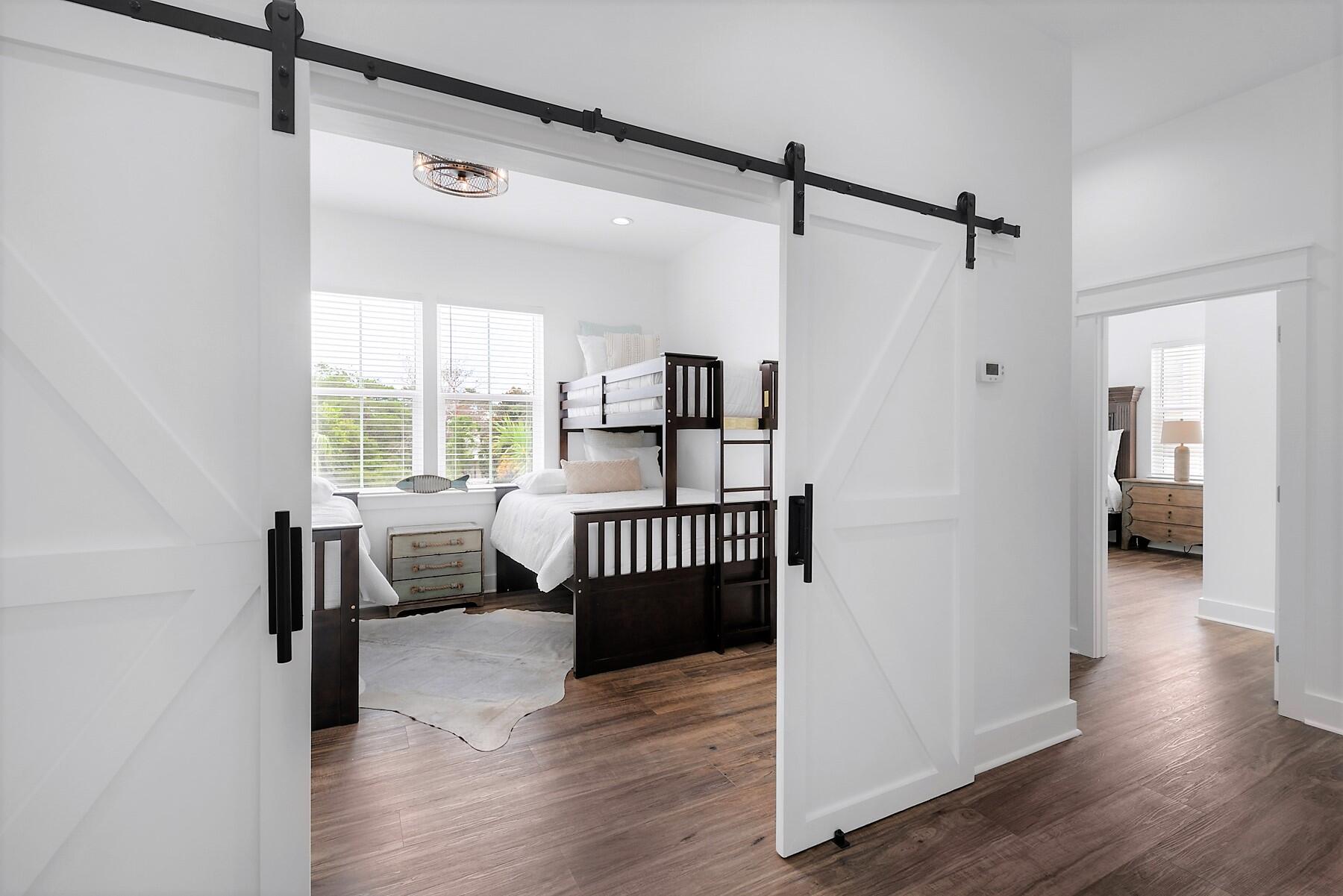 4458 Luke Avenue Destin, FL 32541 - Photo 31 of 41 a bedroom with furniture and wooden floor