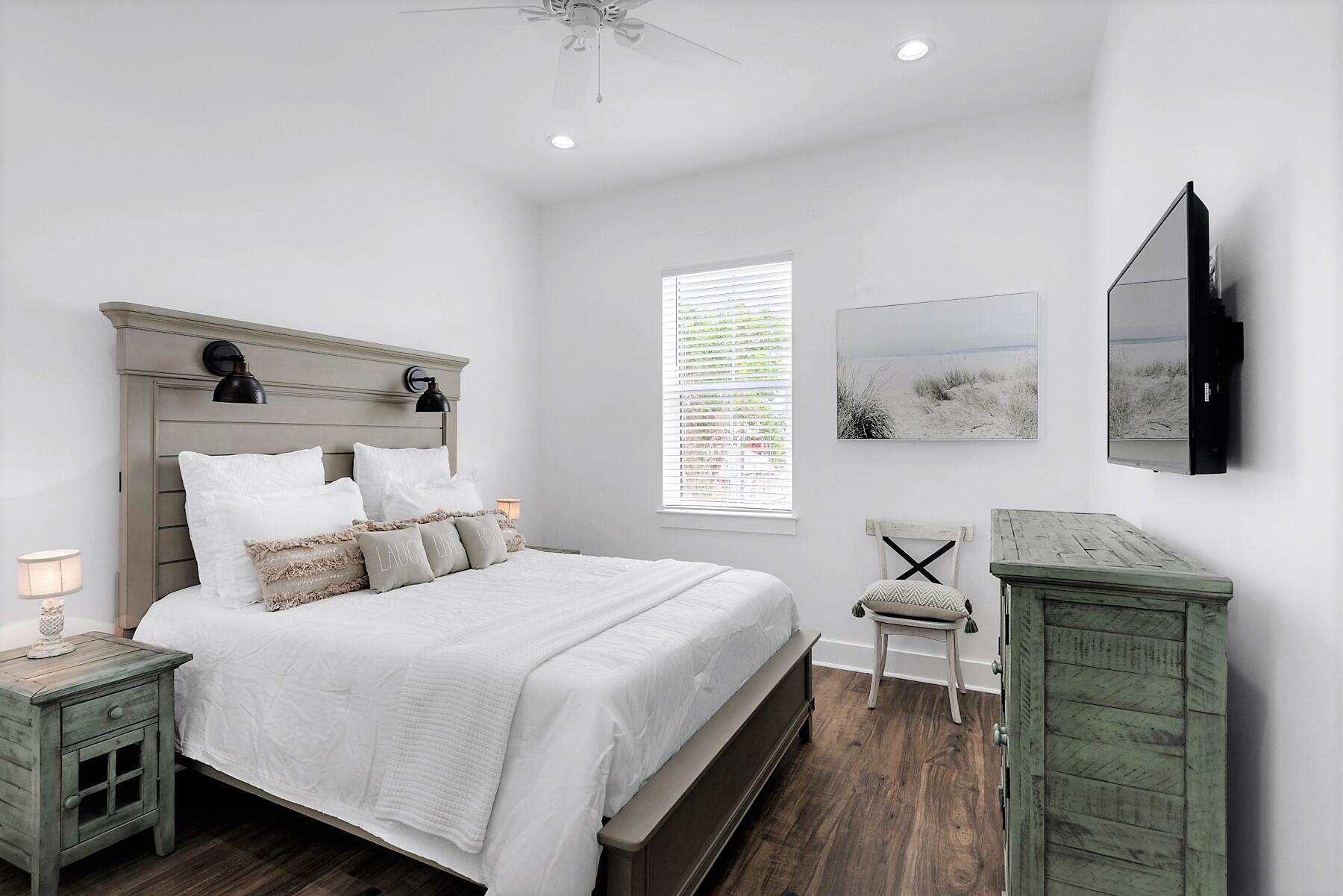 4458 Luke Avenue Destin, FL 32541 - Photo 34 of 41 a bedroom with a bed and a table in it