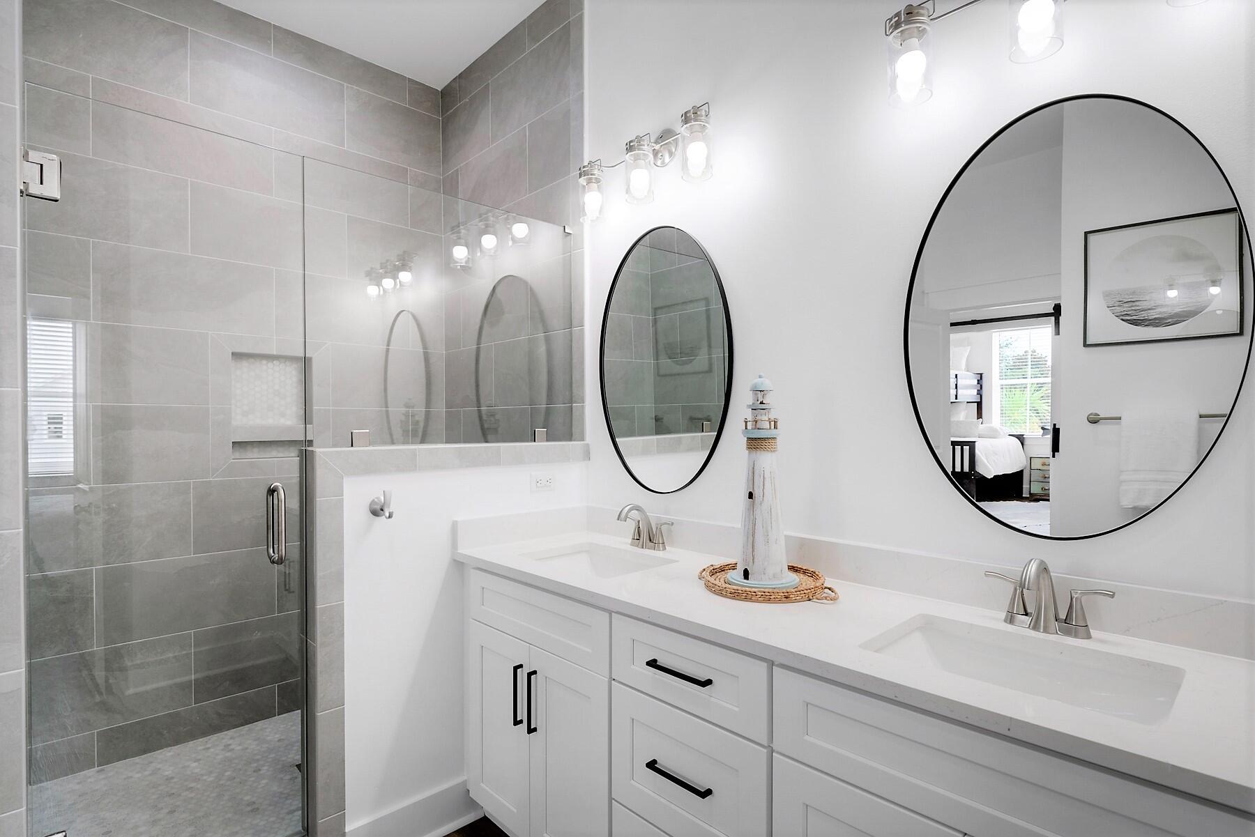 4458 Luke Avenue Destin, FL 32541 - Photo 36 of 41 a bathroom with a double vanity sink and a mirror