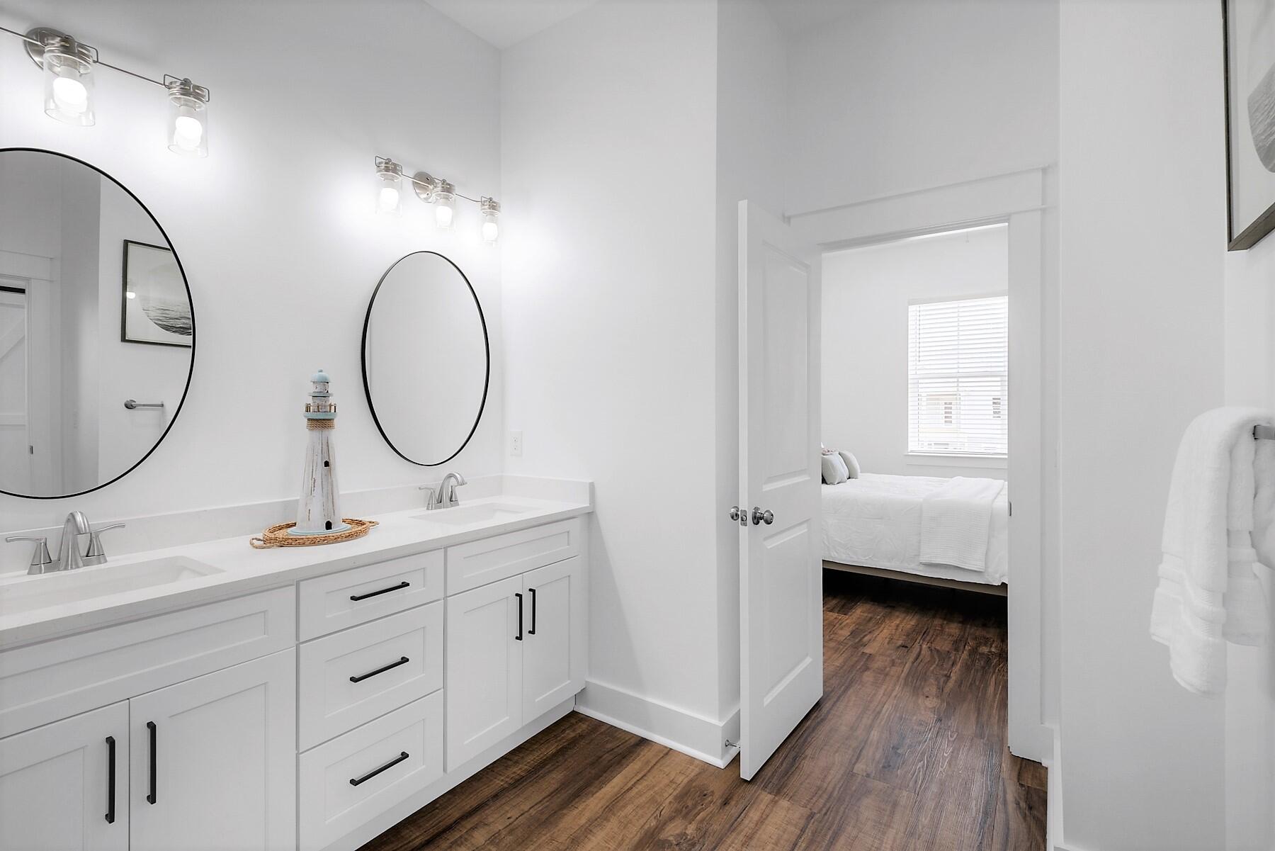4458 Luke Avenue Destin, FL 32541 - Photo 37 of 41 a bathroom with a double vanity sink and a mirror