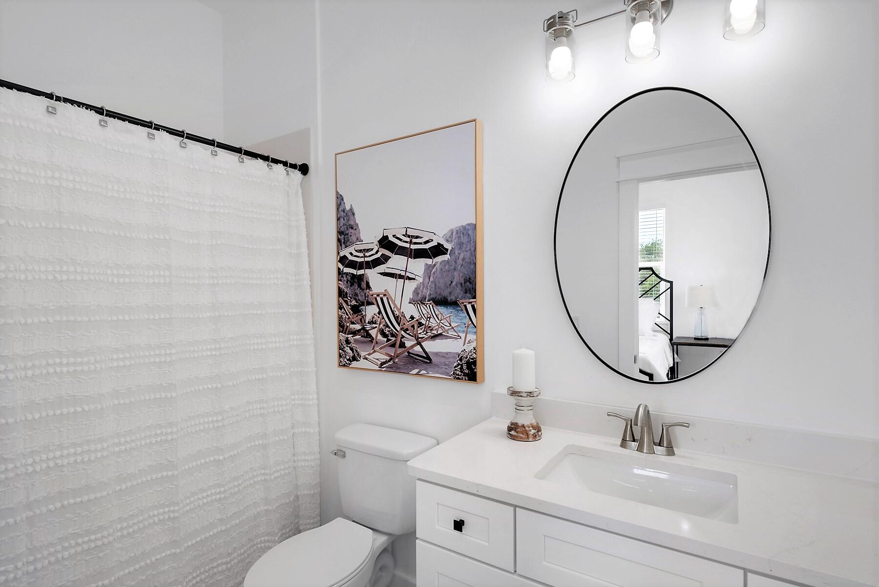 4458 Luke Avenue Destin, FL 32541 - Photo 40 of 41 a bathroom with a toilet sink and mirror