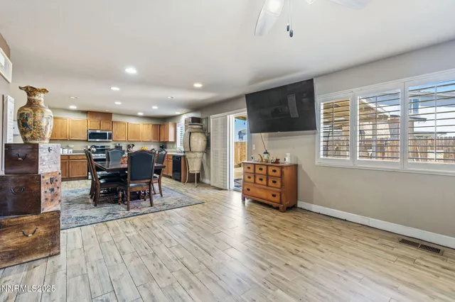 a dining room with furniture and a refrigerator