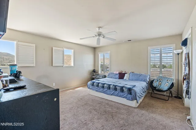 a bedroom with a bed and ceiling fan