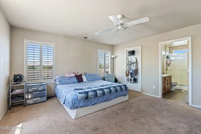 a bathroom with a granite countertop sink a toilet a mirror a vanity and shower