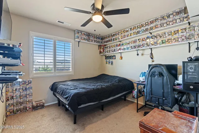 a bedroom with a bed dresser and a desk
