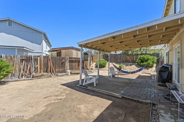 a view of a house with backyard and sitting area