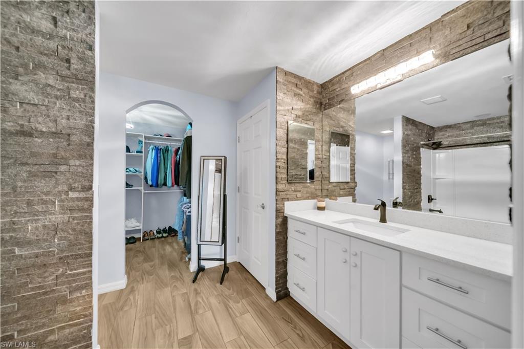 175 Shadowview Court Lehigh Acres, FL 33974 - Photo 22 of 39 a spacious bathroom with a double vanity sink and mirror