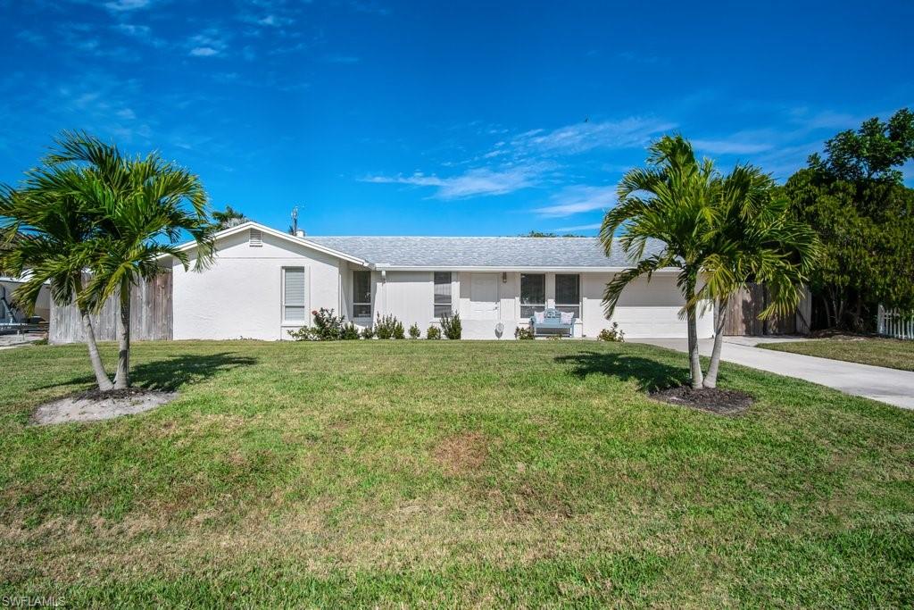 1207 Hernando Street Naples, FL 34103 - Photo 2 of 37 a view of house with backyard and a tree
