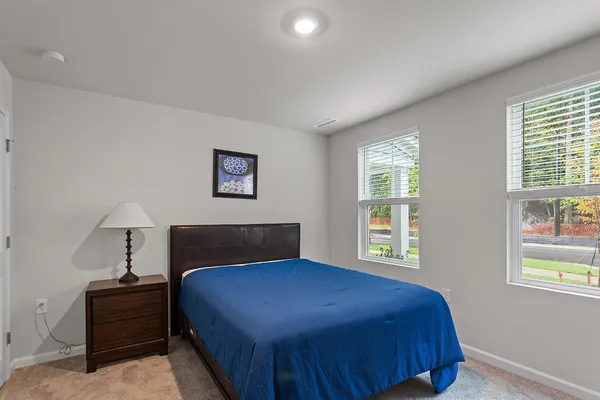 a bedroom with a bed and window