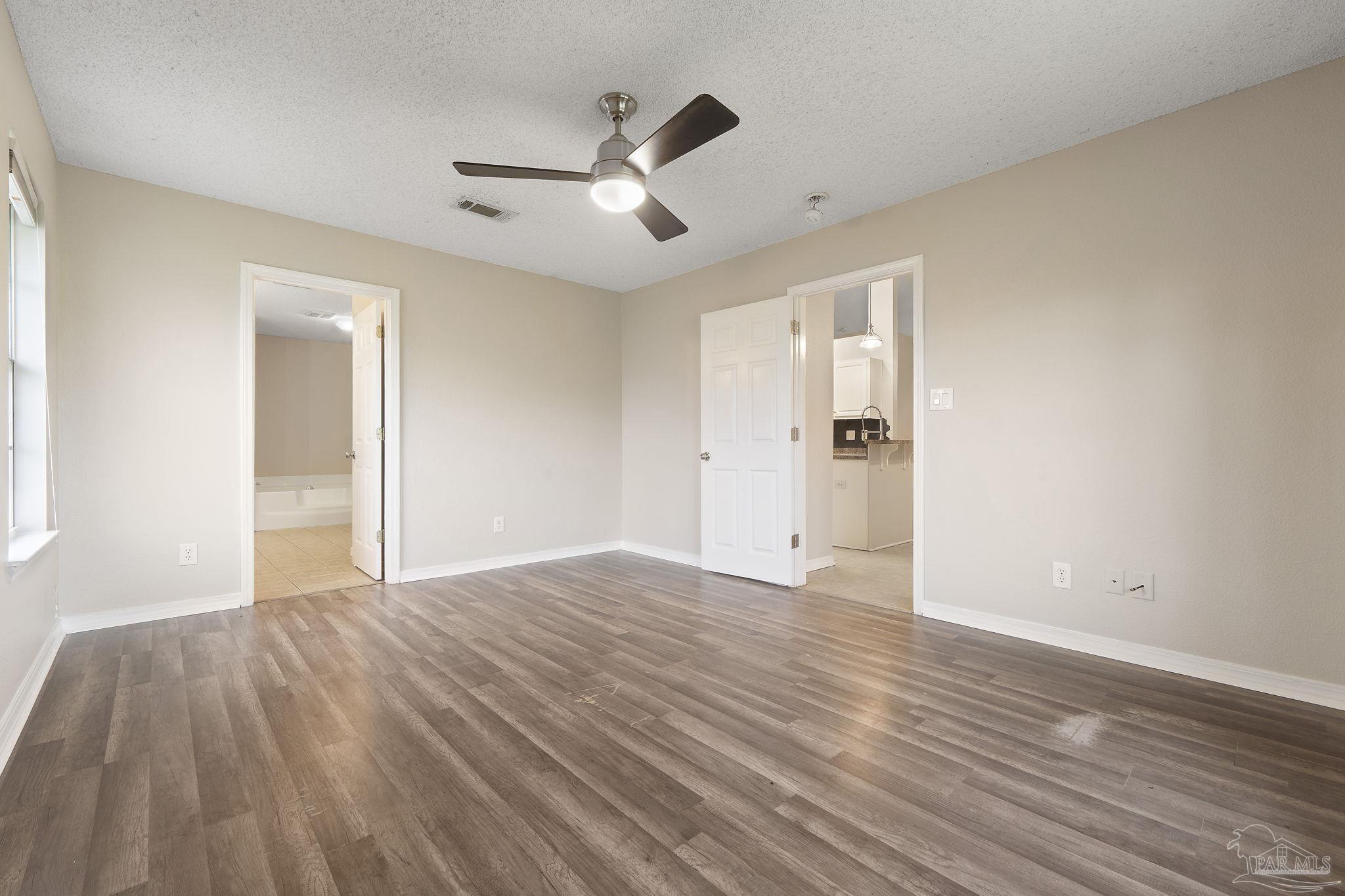 5642 Berrybrook Circle Pace, FL 32571 - Photo 18 of 72 a view of empty room with wooden floor and fan