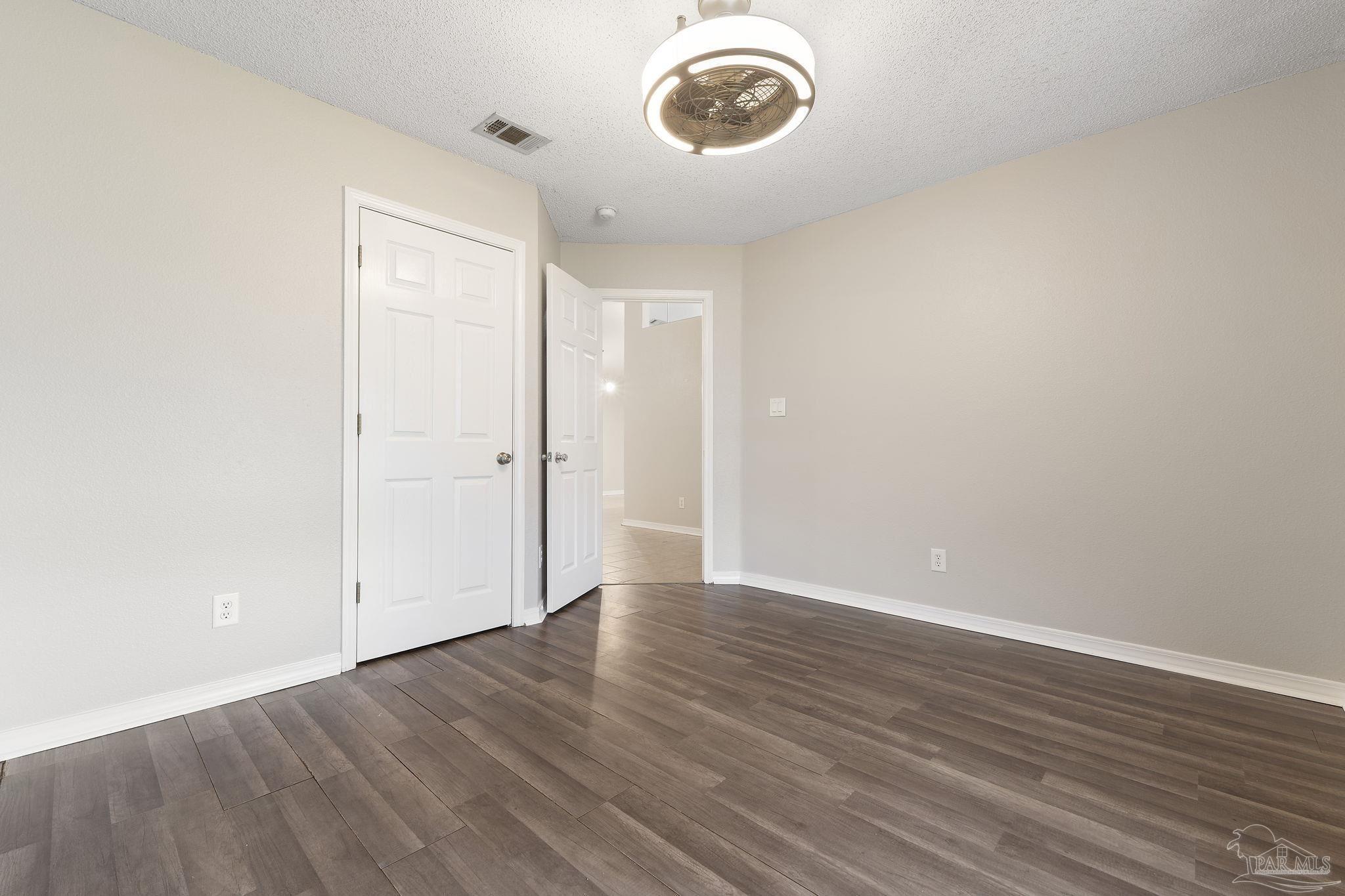 5642 Berrybrook Circle Pace, FL 32571 - Photo 24 of 72 an empty room with wooden floor