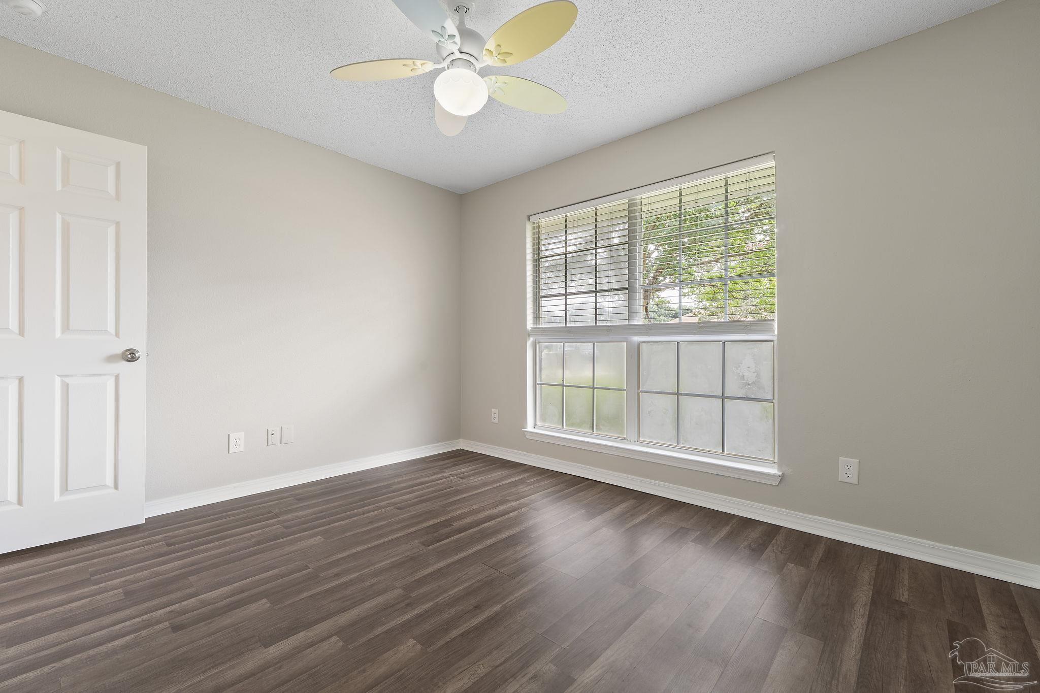 5642 Berrybrook Circle Pace, FL 32571 - Photo 25 of 72 an empty room with wooden floor and windows