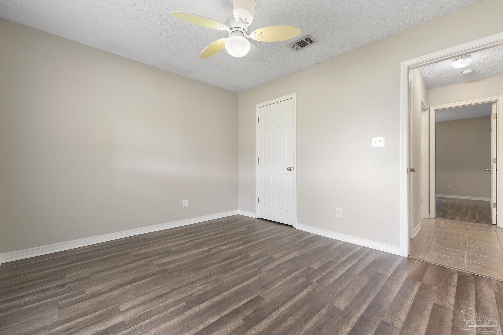 5642 Berrybrook Circle Pace, FL 32571 - Photo 26 of 72 a view of an empty room with wooden floor