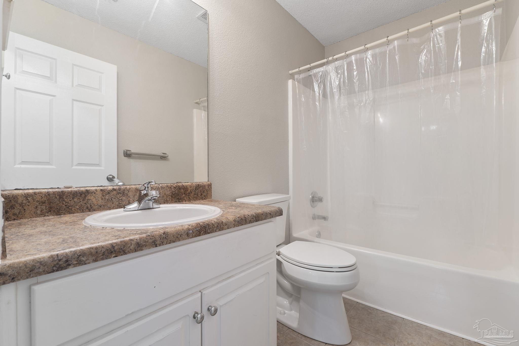 5642 Berrybrook Circle Pace, FL 32571 - Photo 30 of 72 a bathroom with a granite countertop sink a toilet and a mirror
