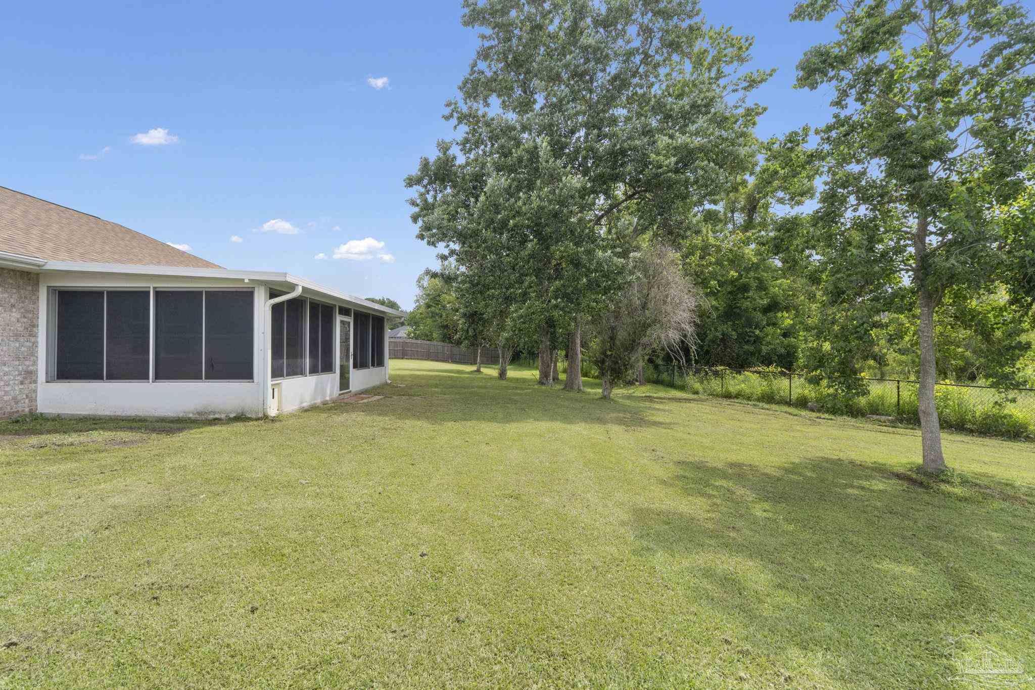 5642 Berrybrook Circle Pace, FL 32571 - Photo 34 of 72 a view of an house with backyard and trees