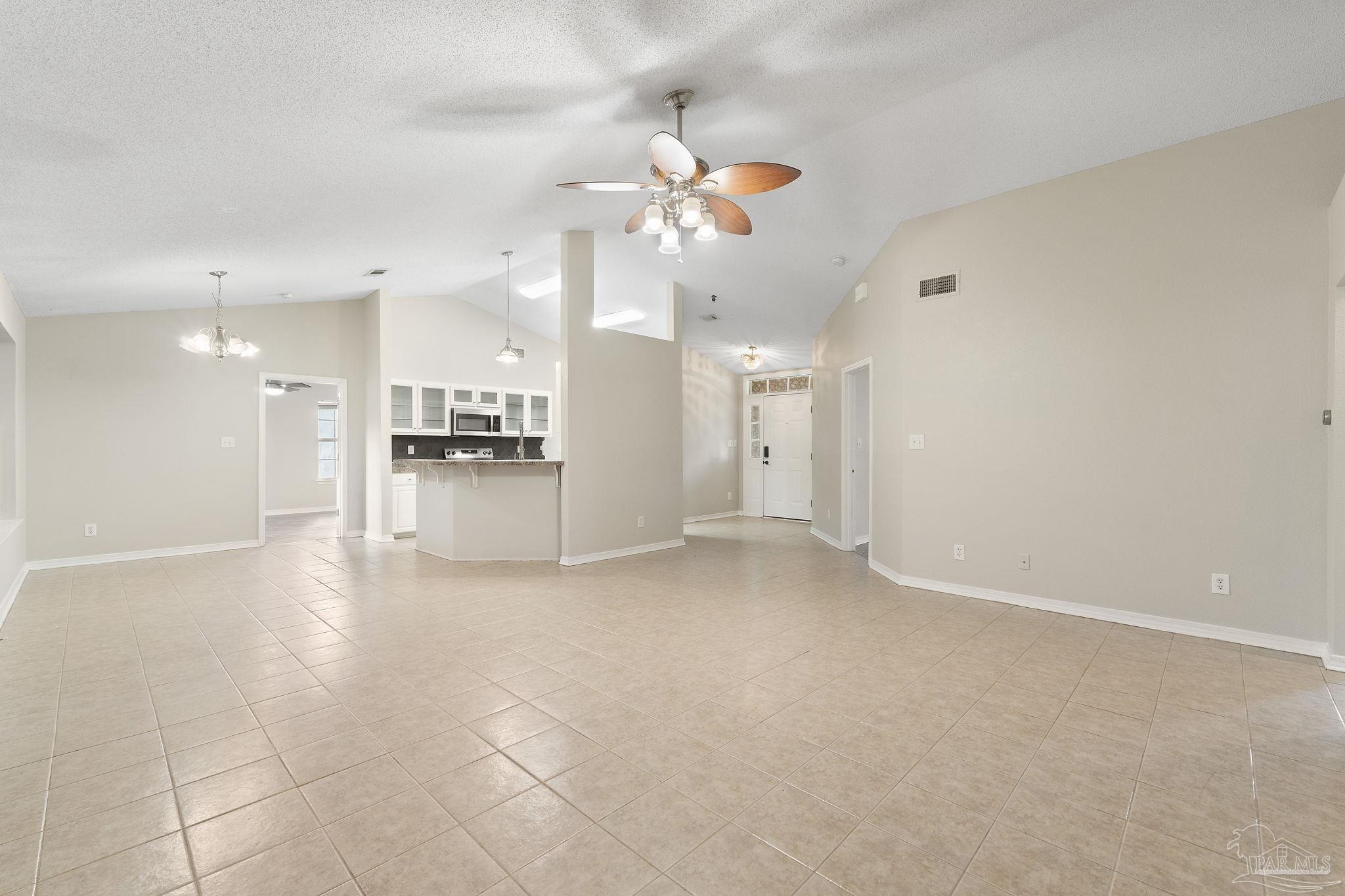 5642 Berrybrook Circle Pace, FL 32571 - Photo 5 of 72 a view of a kitchen with a sink and a refrigerator