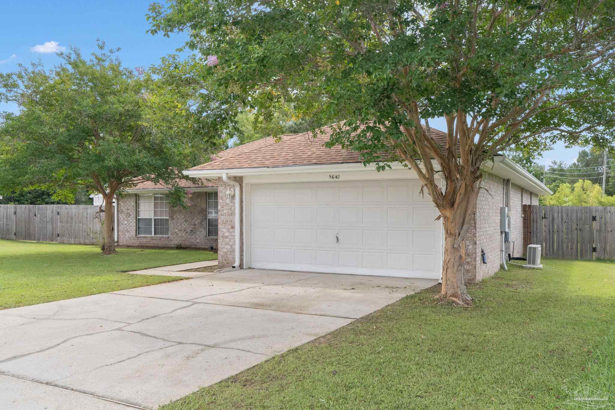 5642 Berrybrook Circle Pace, FL 32571 - Photo 71 of 72 a front view of a house with a yard and garage