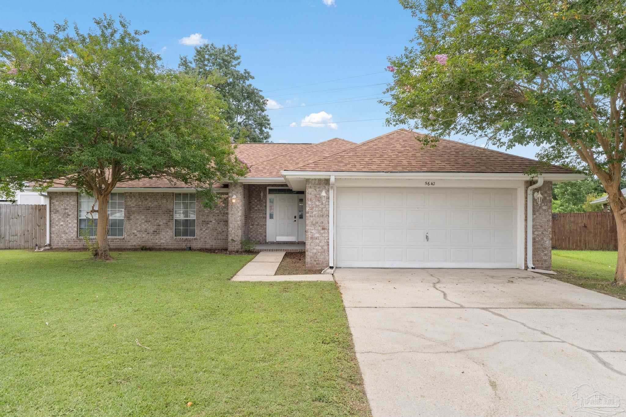 5642 Berrybrook Circle Pace, FL 32571 - Photo 72 of 72 a view of a house with a yard plants and a large tree