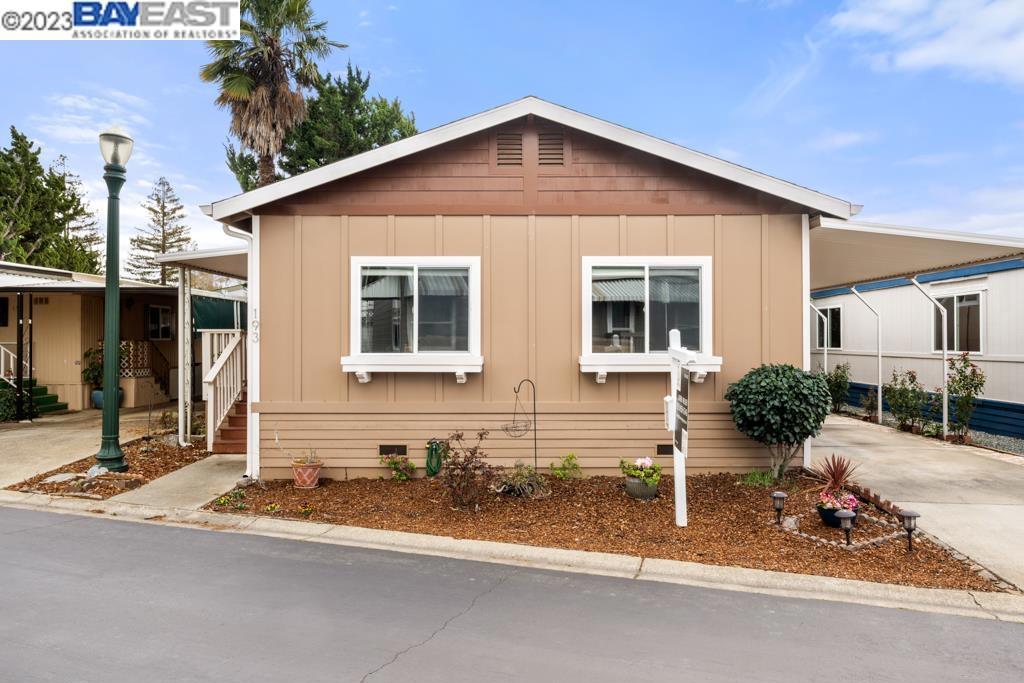 a front view of a house with yard and glass windows