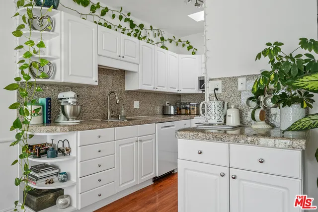 a kitchen with white cabinets and a stove
