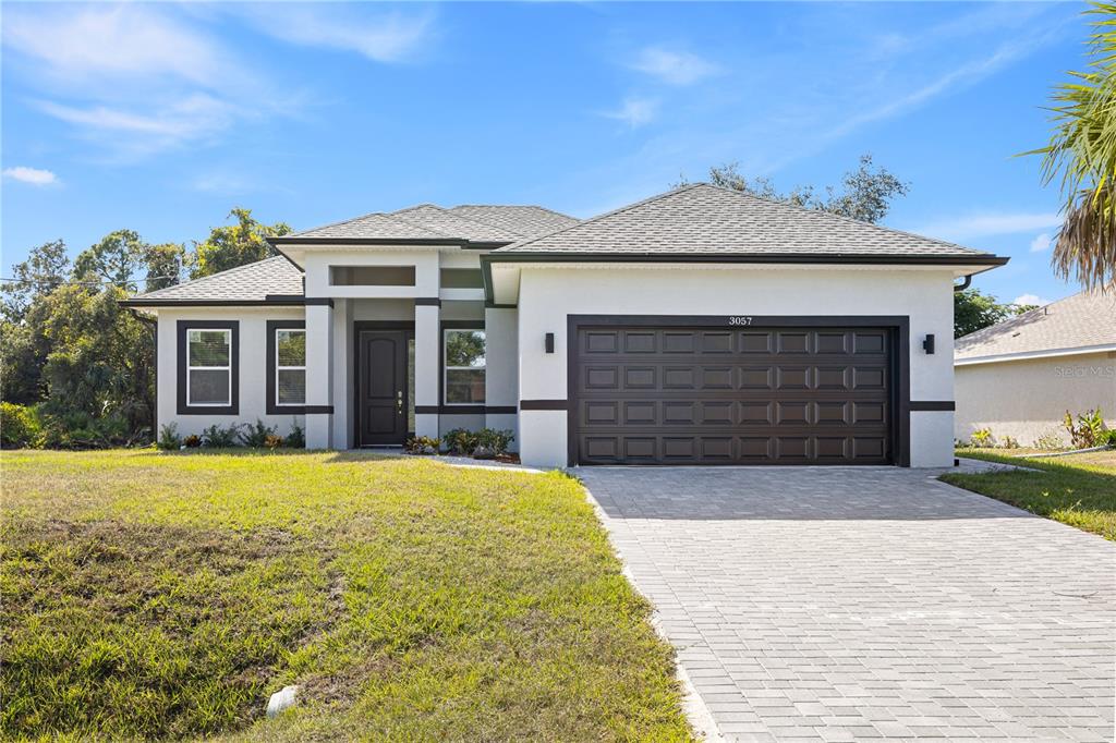 a front view of a house with a yard and garage