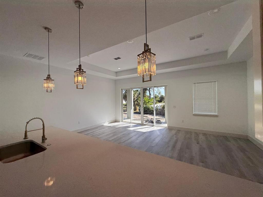 3057 Aliceville Road North Port, FL 34288 - Photo 11 of 33 a view of a room with a ceiling fan and wooden floor